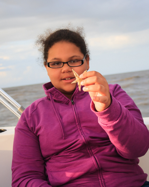 Natalie examines the regenerative powers of a sea star : Edisto Island, SC : JonPargas